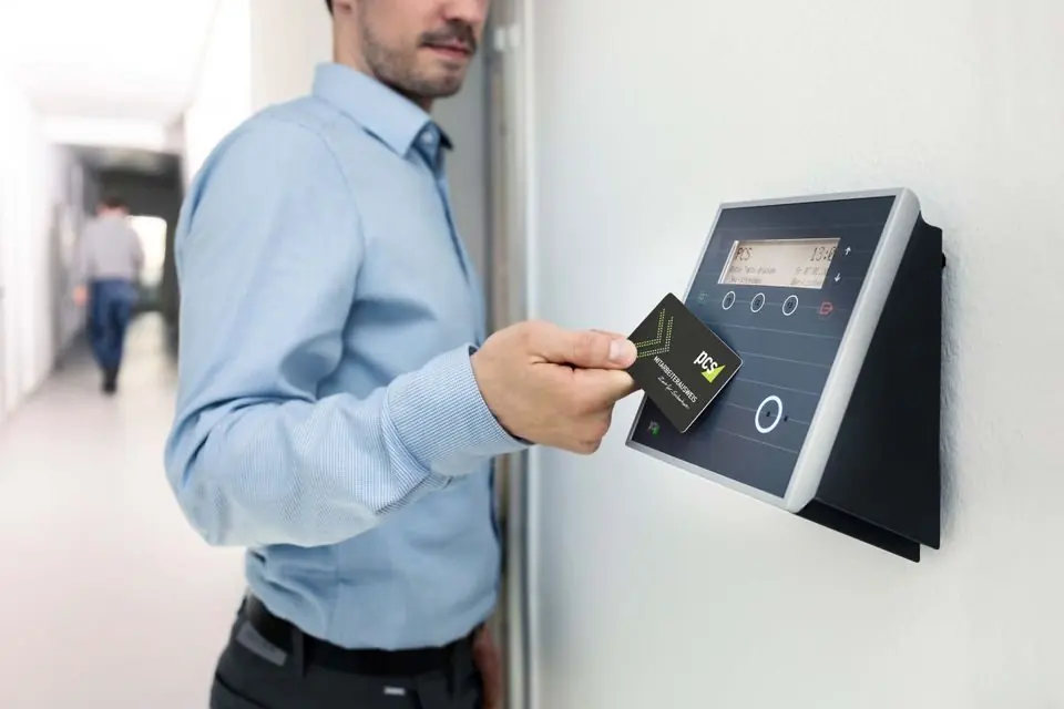 Close up of Man Holding Access Card over Reader