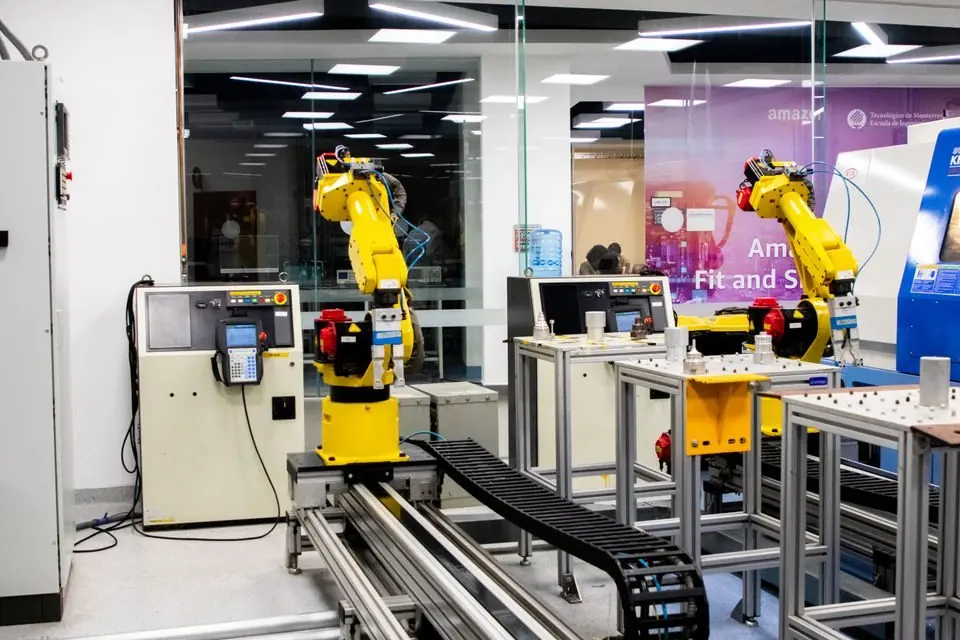 Robots are working in a factory with a machine