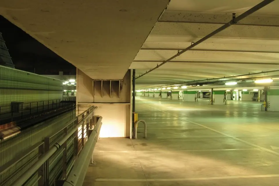 Illuminated Empty Floor of a Parking Garage at Night