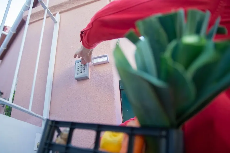 A Person Using a Gate Keypad